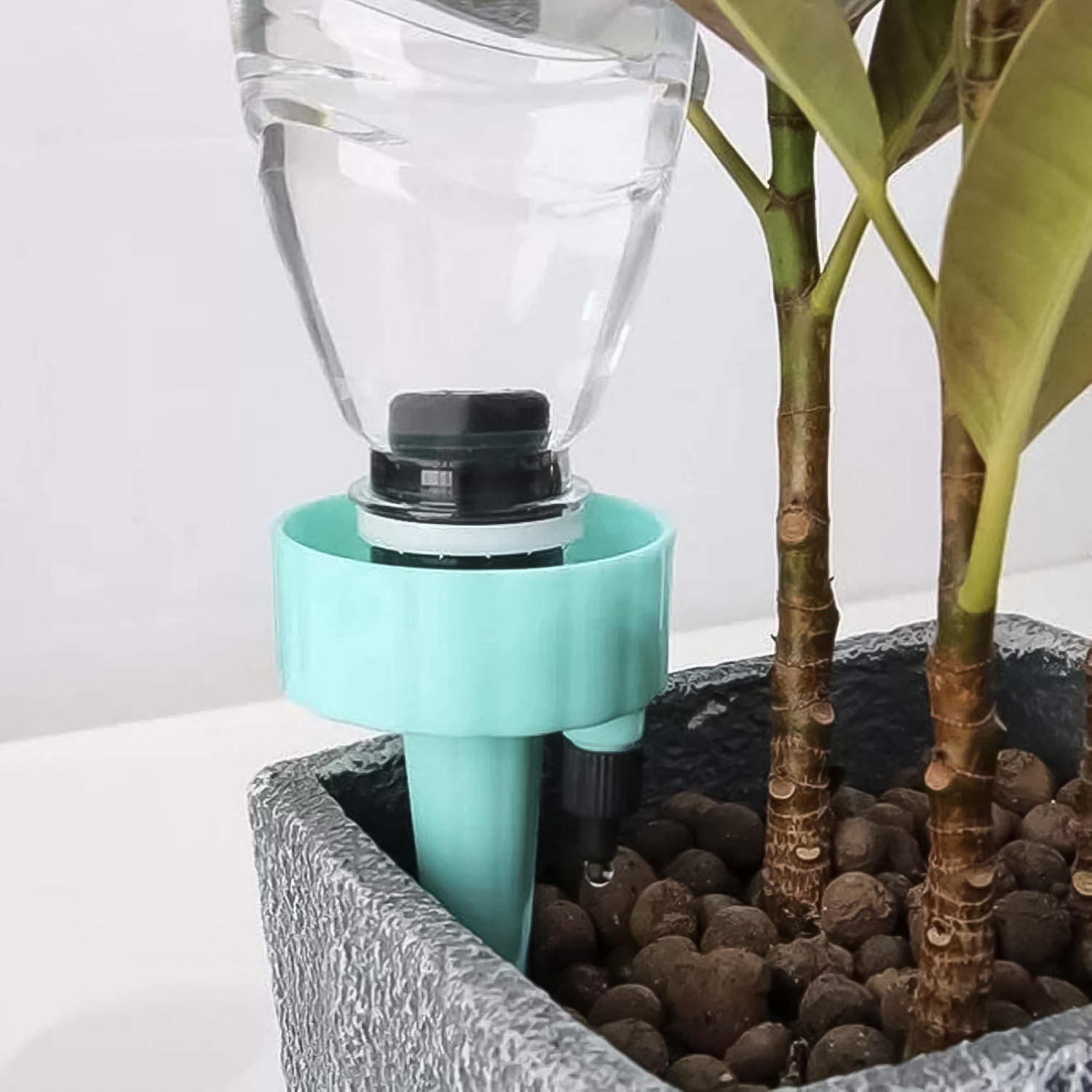 Wukusy automatic plant watering spikes inserted in plant pot with water bottle for self-watering