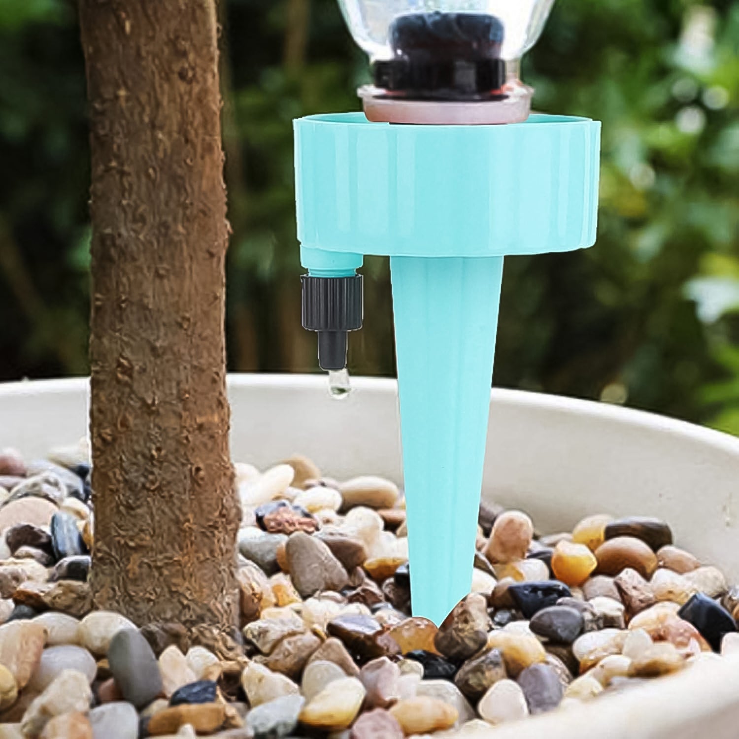 Wukusy automatic plant watering spikes in blue inserted in potted plant with pebbles for garden use