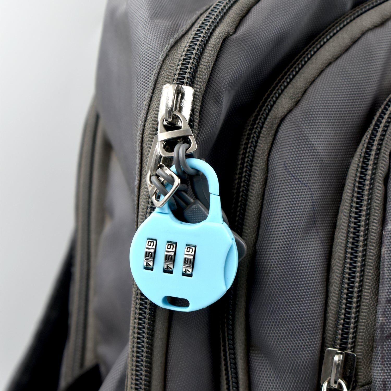 Wukusy blue combination lock for luggage attached to gray backpack zipper for security