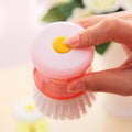 Wukusy cleaning brush with soap dispenser in hand, white bristles and orange soap container