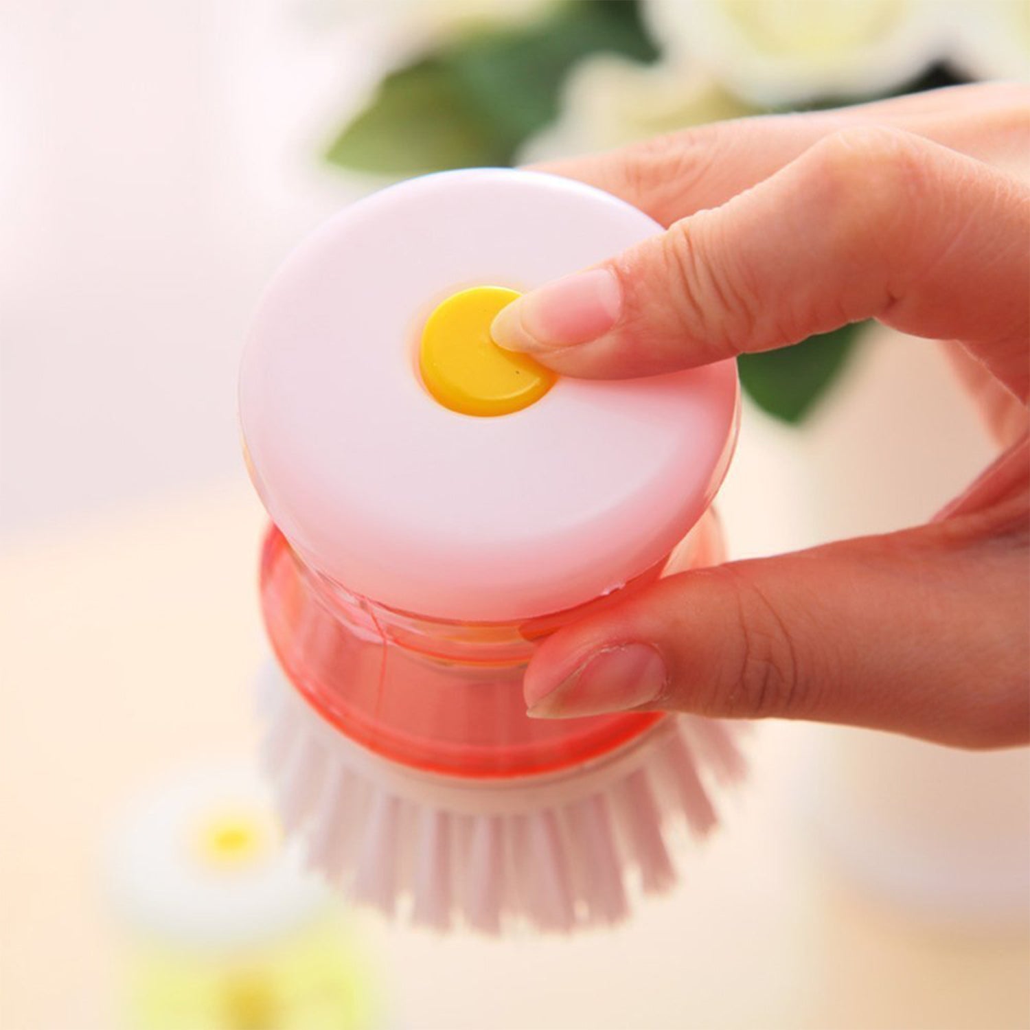 Wukusy cleaning brush with soap dispenser in hand, white bristles and orange soap container