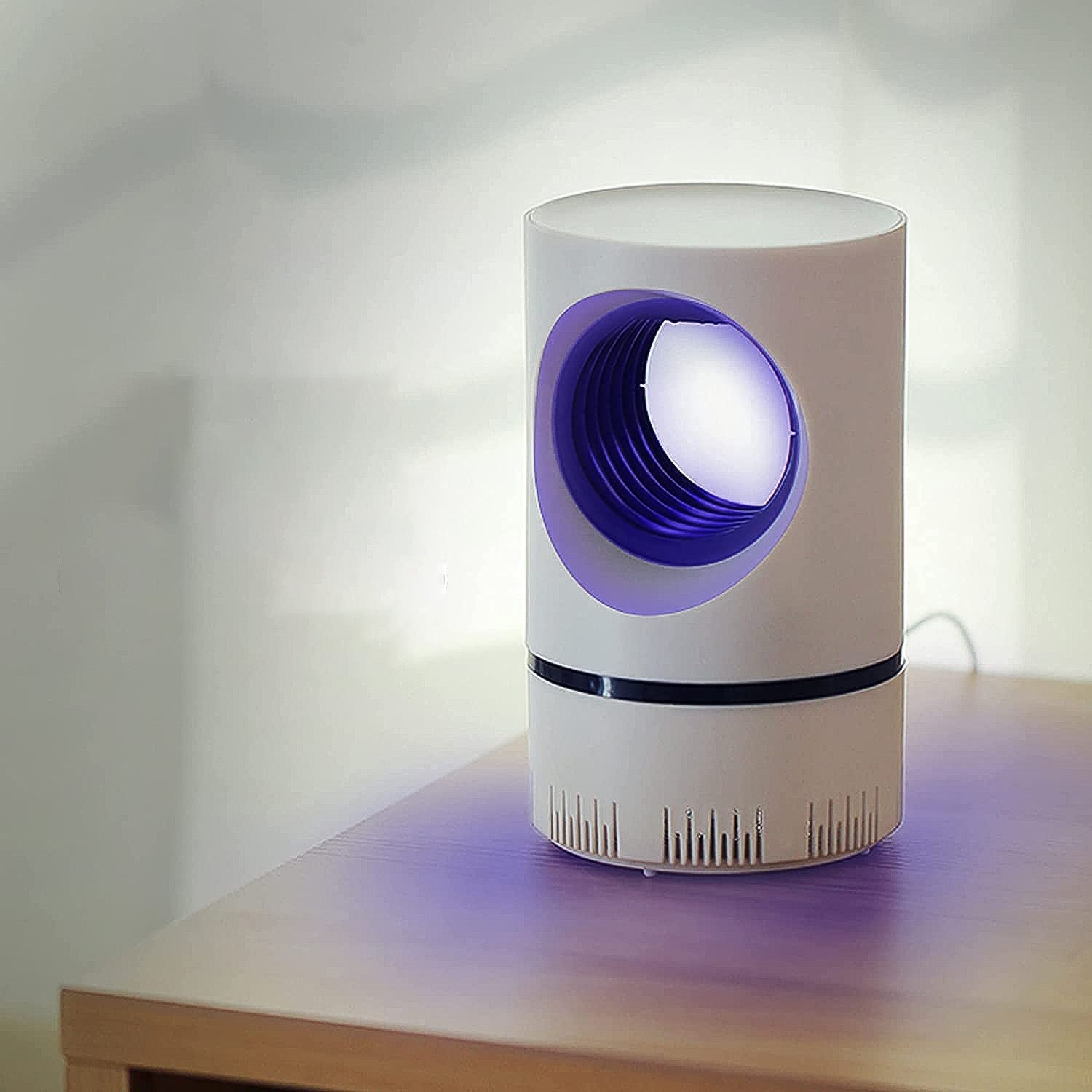 Wukusy electric mosquito killer machine in white with purple light on wooden table for indoor use