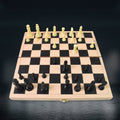 Wukusy folding wooden chess board with black and white pieces set up for play
