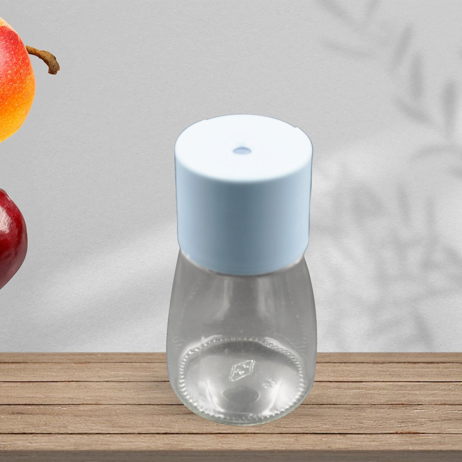 Wukusy glass salt bottle set with clear body and white cap on wooden surface