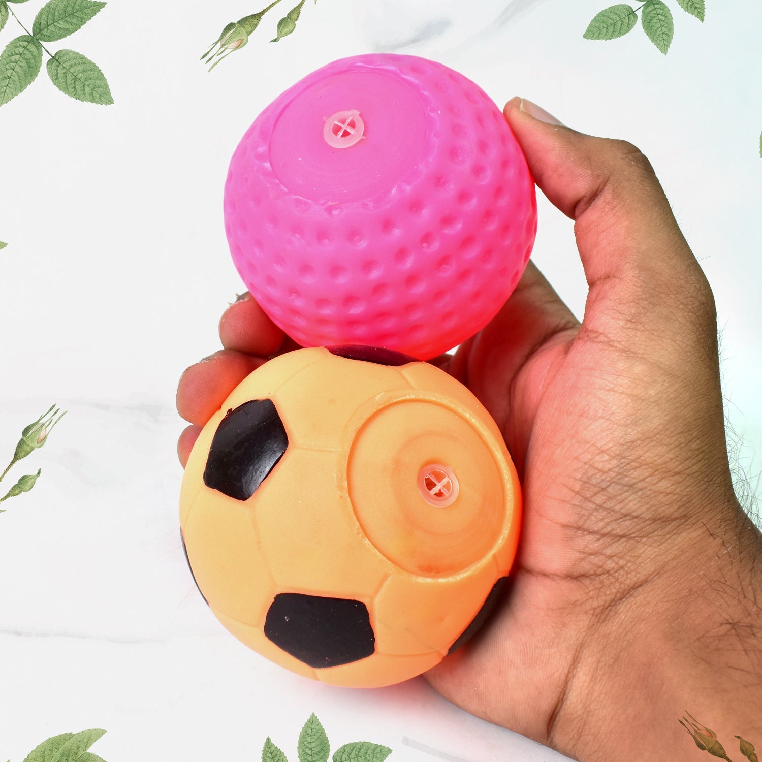 Wukusy sports squeeze balls for kids in pink and orange soccer ball design held in hand