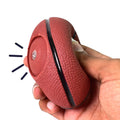 Wukusy sports squeeze balls for kids in red textured basketball design being squeezed by hand