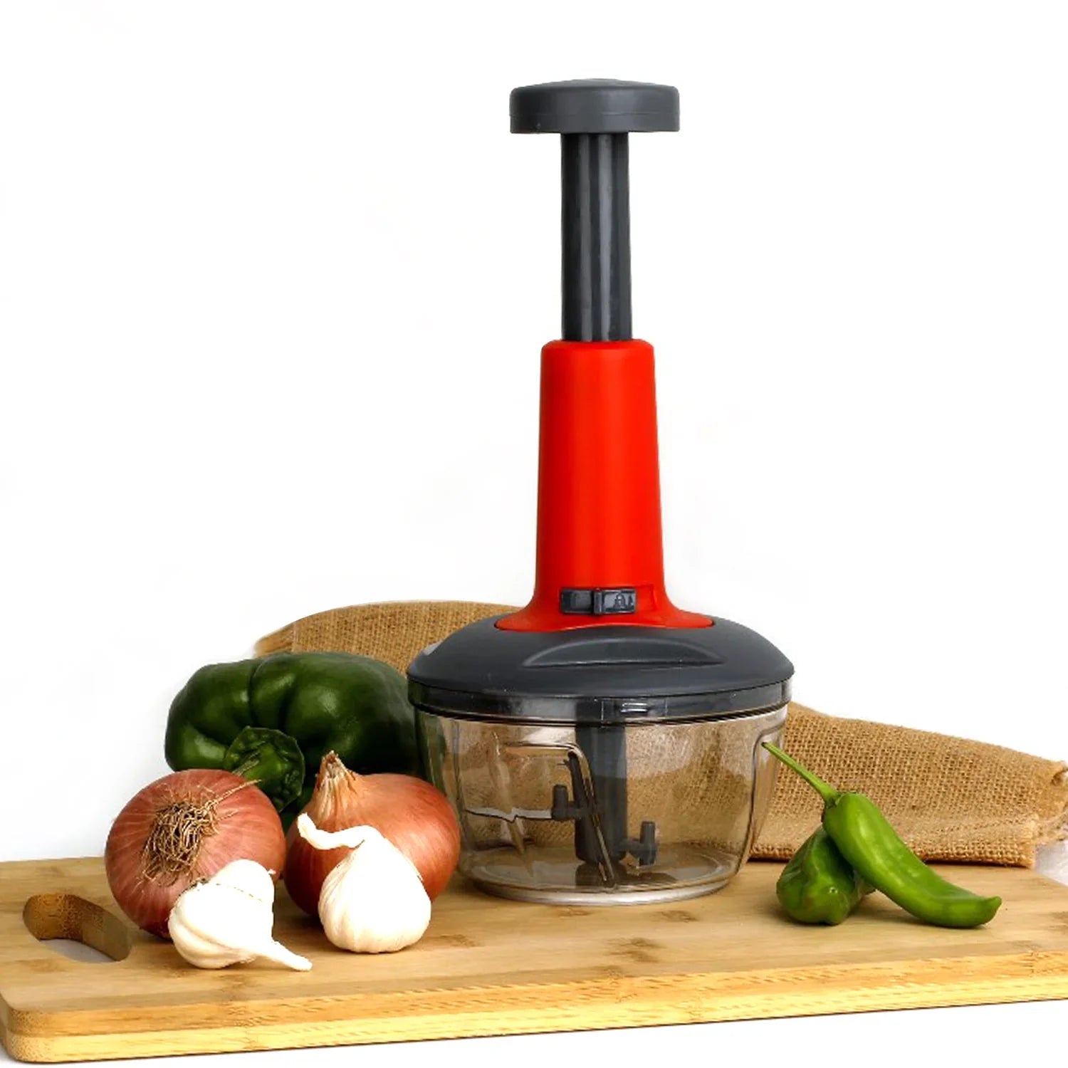 Manual Hand Press Chopper for Easy Kitchen Prep - Market FindsMarket Findsmanual hand press chopper with red handle on wooden cutting board with vegetables