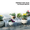Wukusy metal balcony plant stand holding various flower pots for outdoor garden decor