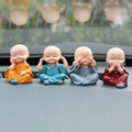 Miniature Buddha Decor for Car Dashboard Set - Market FindsMarket Findsminiature Buddha decor for car dashboard featuring four small meditating monk figurines in colorful robes