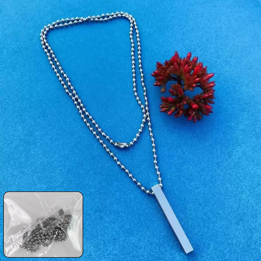 Wukusy minimalist bar pendant necklace in silver with a sleek rectangular pendant and ball chain on blue background