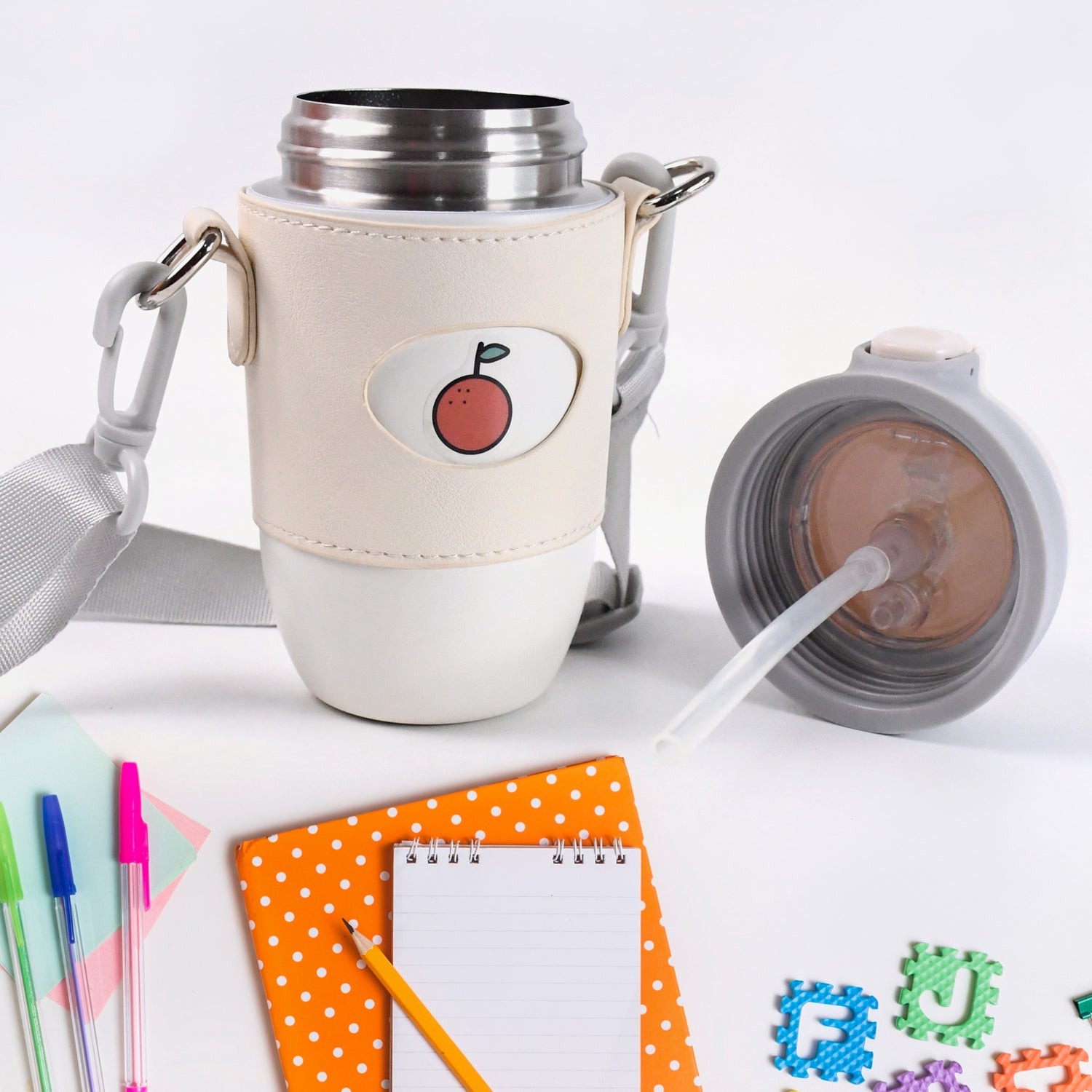 Stainless Steel Insulated Water Bottle with Strap - Market FindsMarket Findsstainless steel insulated water bottle with beige sleeve and straw lid on a white desk