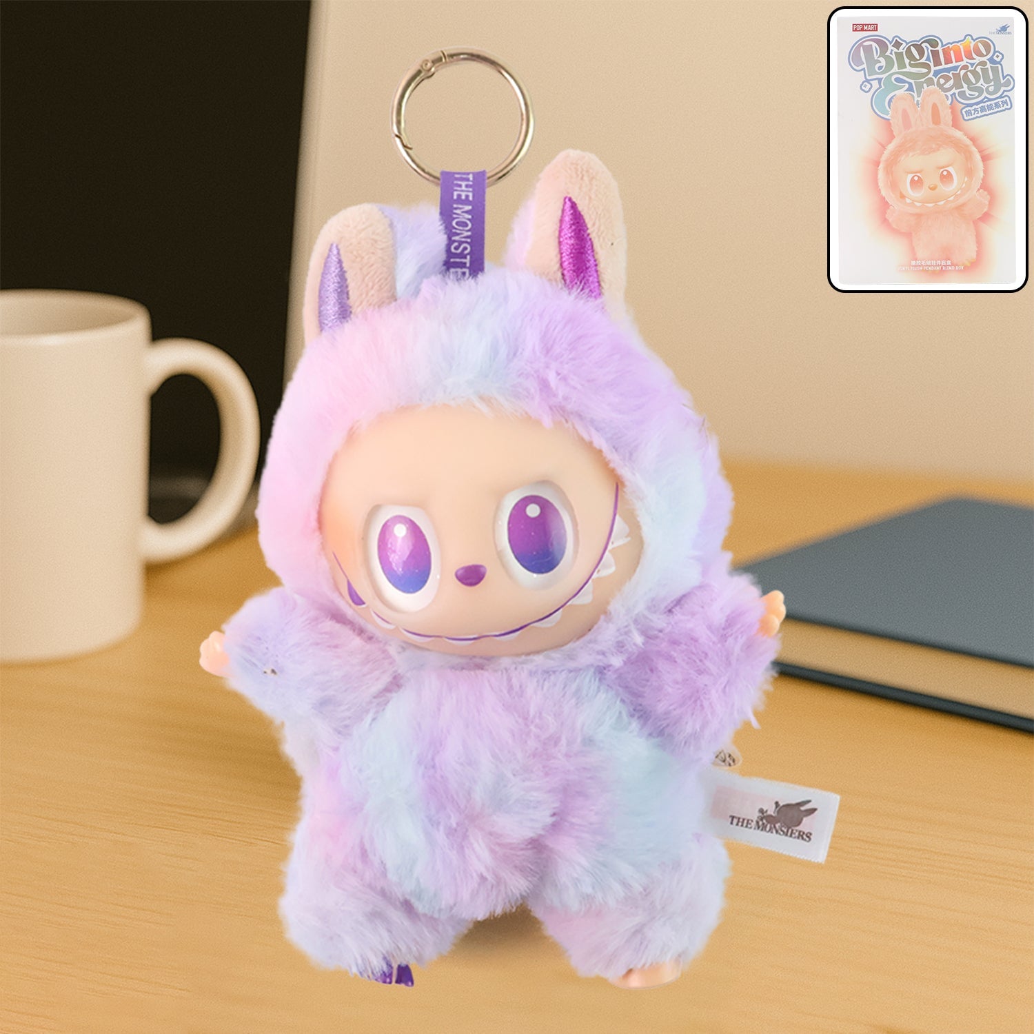Wukusy light purple plush keychain with pastel colors and large eyes on wooden desk