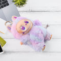Wukusy light purple plush keychain featuring a cute multi-colored fuzzy character with big eyes on a white wooden surface
